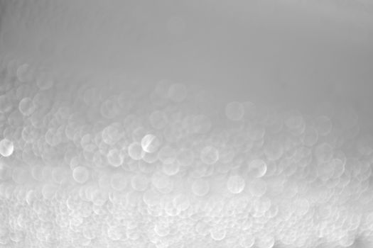 Blurred white bokeh lights create an abstract and soothing background texture.