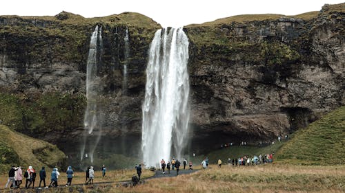 Free People Standing Near Waterfalls Stock Photo