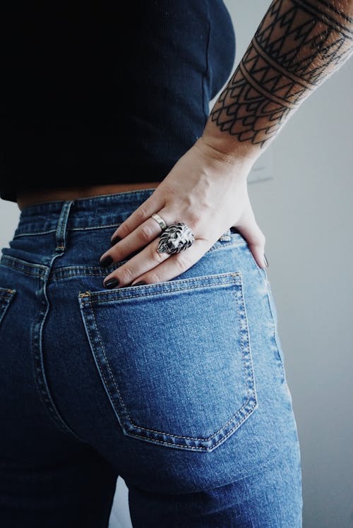 Free Woman in Blue Jeans with Hand on Waist  Stock Photo