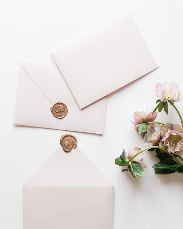 Free Three White Envelopes and bunch of Pink Flowers Stock Photo