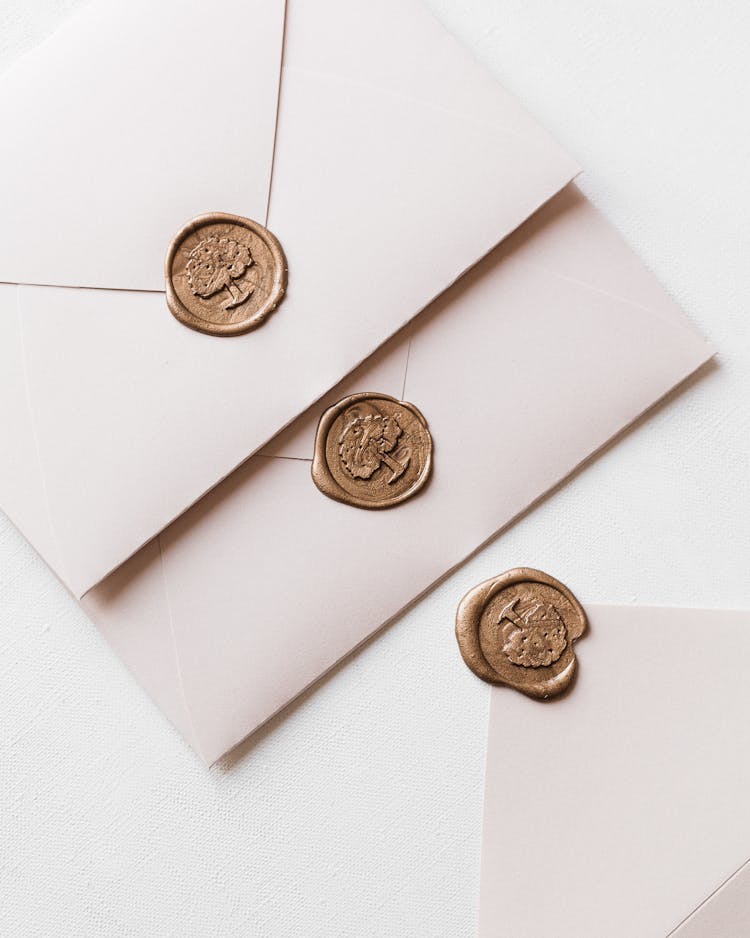 Three White Envelopes With Wax Seal Arranged In Row