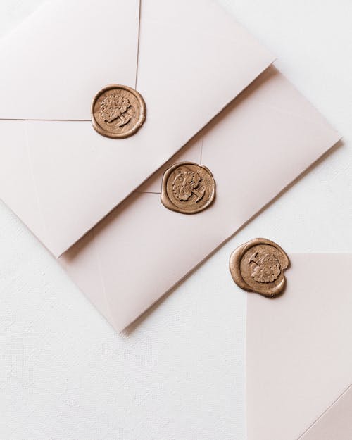 Free Wax Sealed Envelopes and One Opened Laying on White Surface Stock Photo