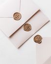 Wax Sealed Envelopes and One Opened Laying on White Surface