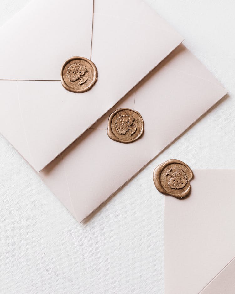 Wax Sealed Envelopes And One Opened Laying On White Surface