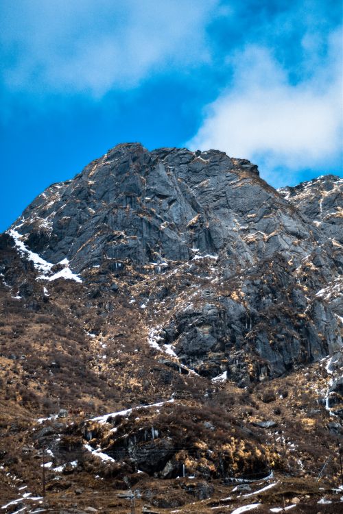 Free Majestic rugged mountains with snow patches under a clear blue sky in Sikkim, India. Stock Photo