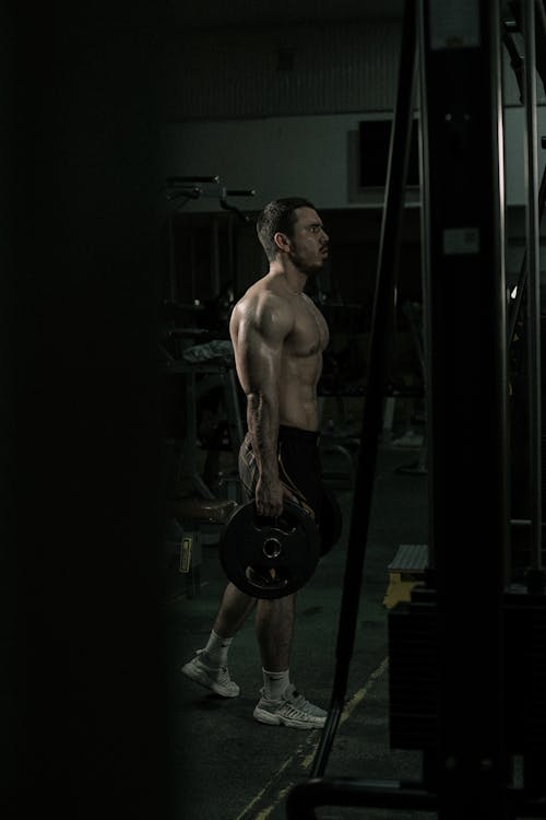 A Topless Man Doing a Workout