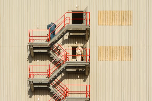 Workers Working on Stairs on Building Wall