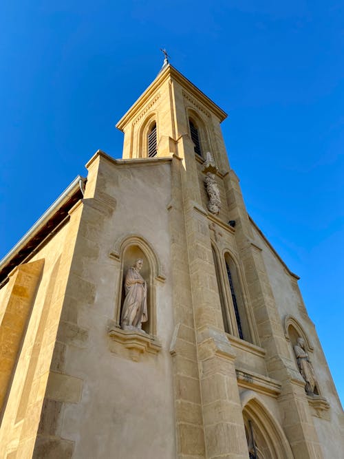 Low Angle Shot of a Church Under Blue Sky