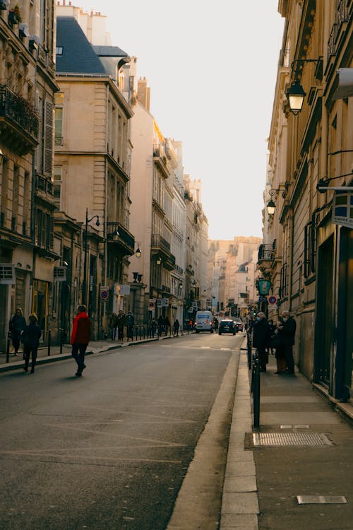 People Walking on Sidewalks of a Busy Street