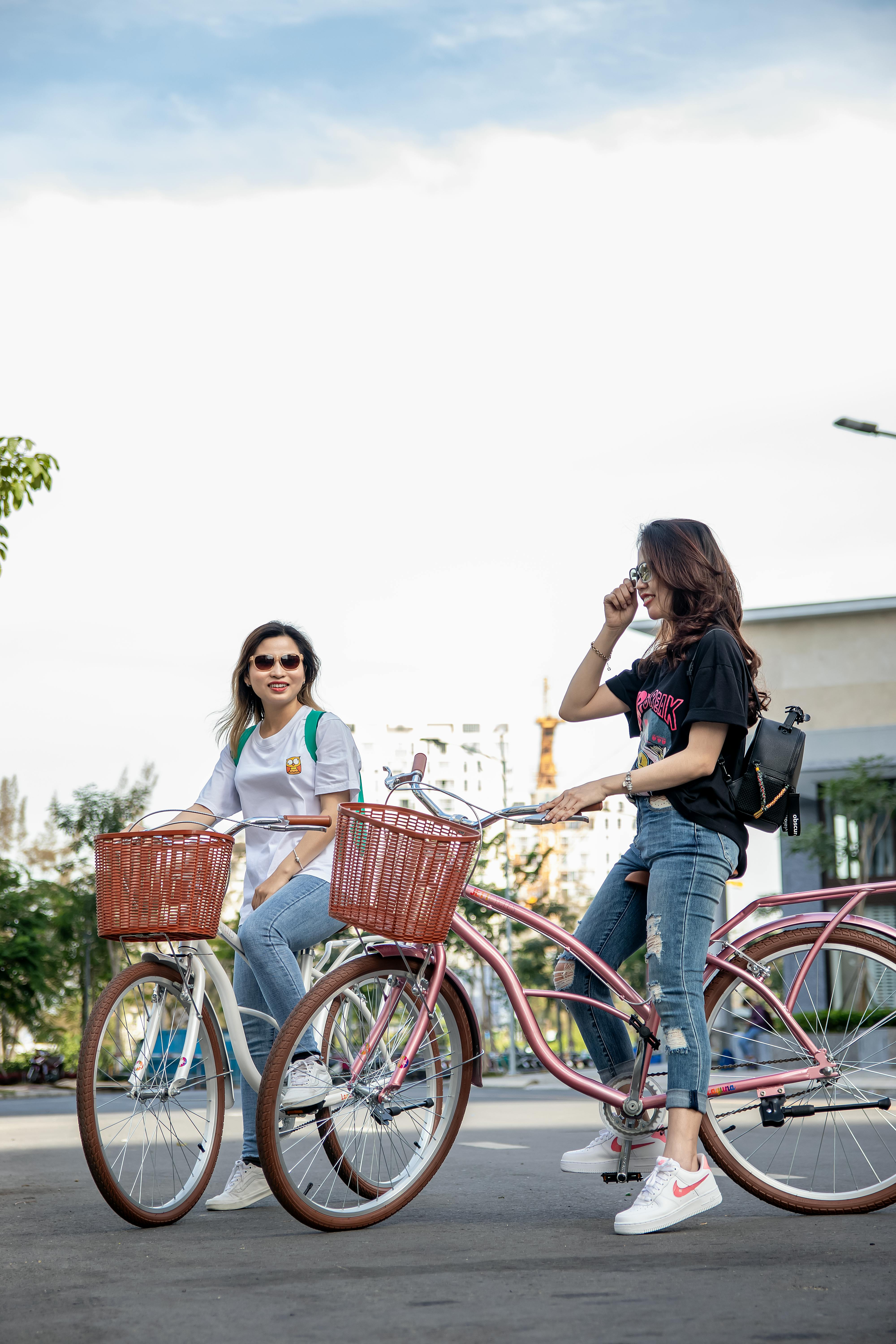 Woman in Black T-shirt and Blue Denim Jeans Standing Beside Red