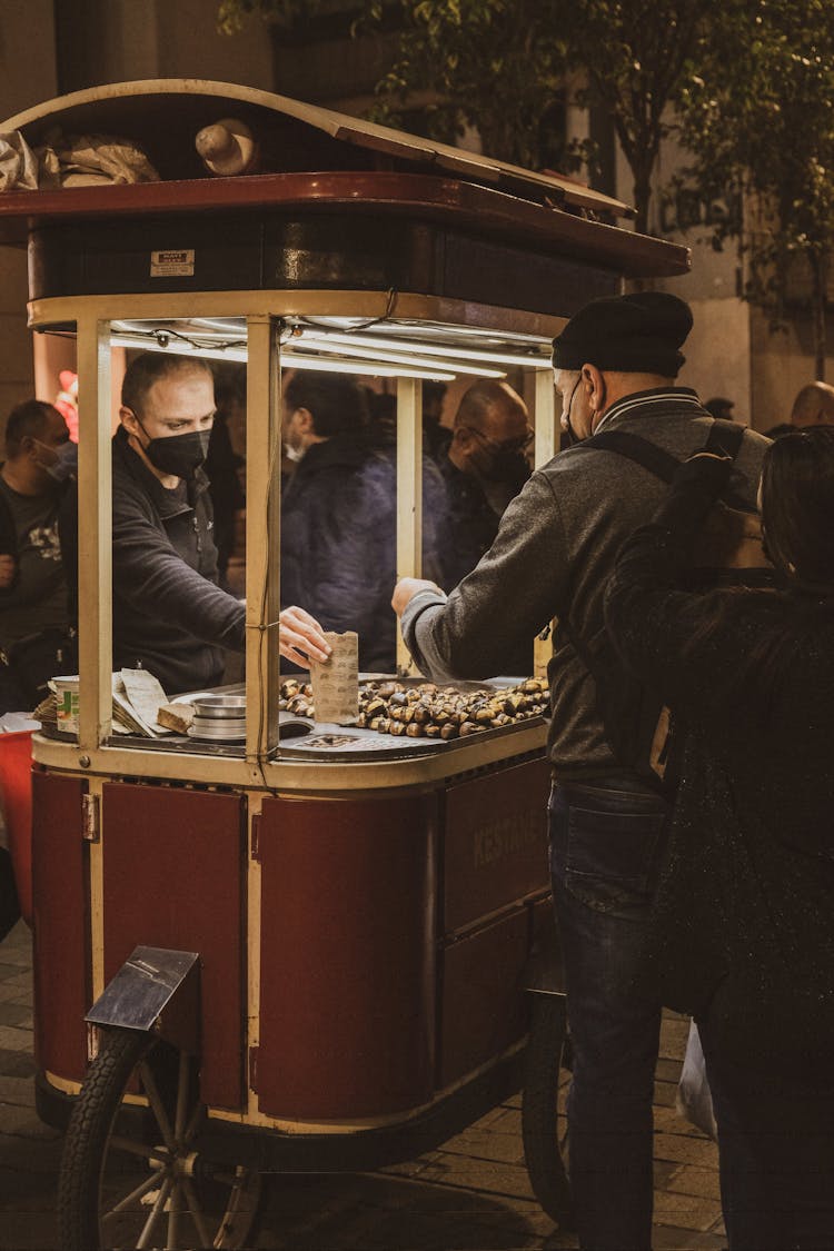 Man Buying At A Food Cart