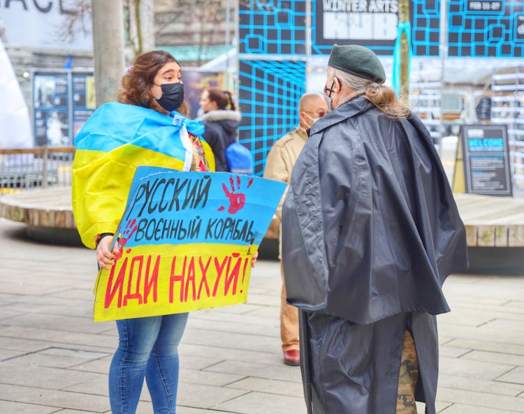 A Person With A Banner In A City