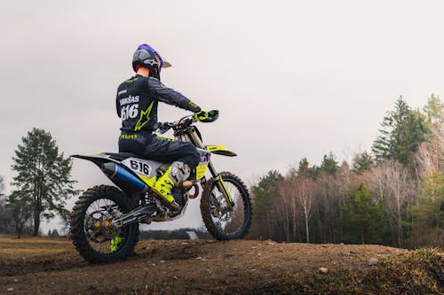 Man Wearing a Helmet Riding a Dirt Bike