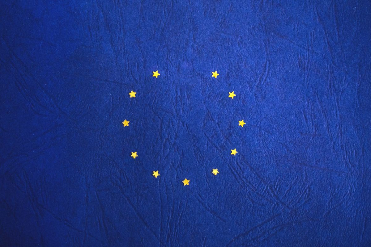 The circle of yellow stars of the European Union flag on a blue background