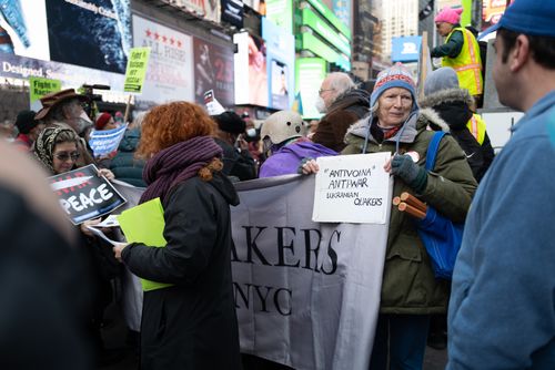 Free A diverse group of adults engage in a peaceful anti-war protest in an urban area. Stock Photo