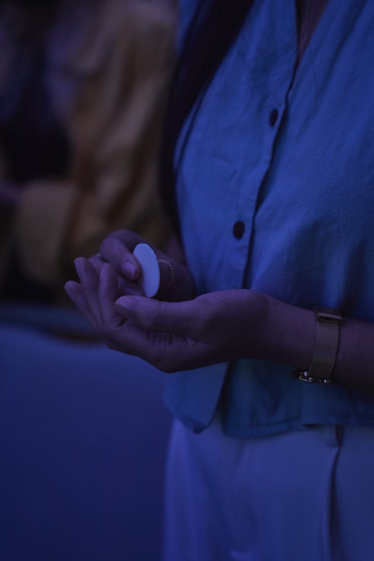 Woman Holding A Eucharist Wafer