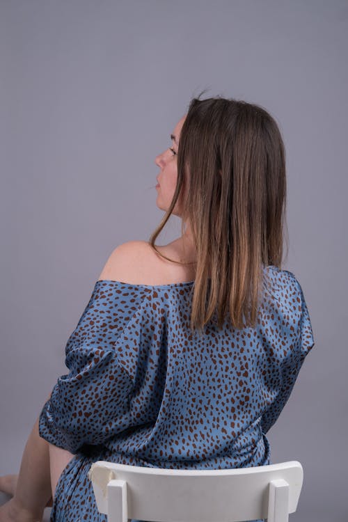 Woman in Blue Printed Dress Looking Away