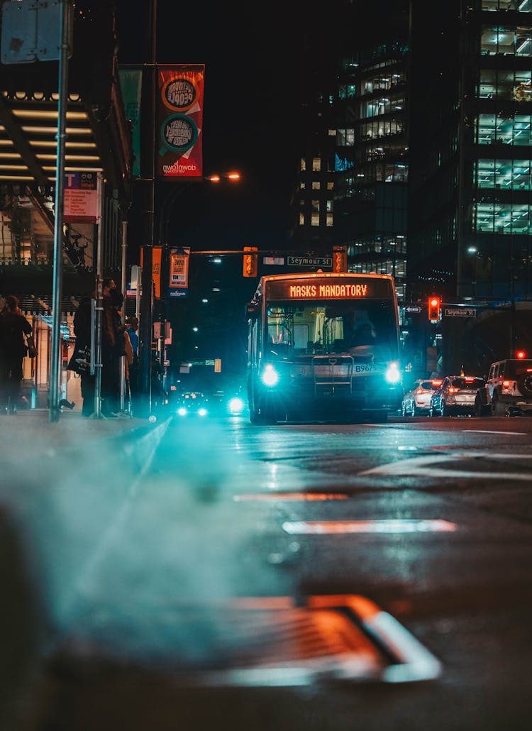 A Moving Bus On The Road At Night