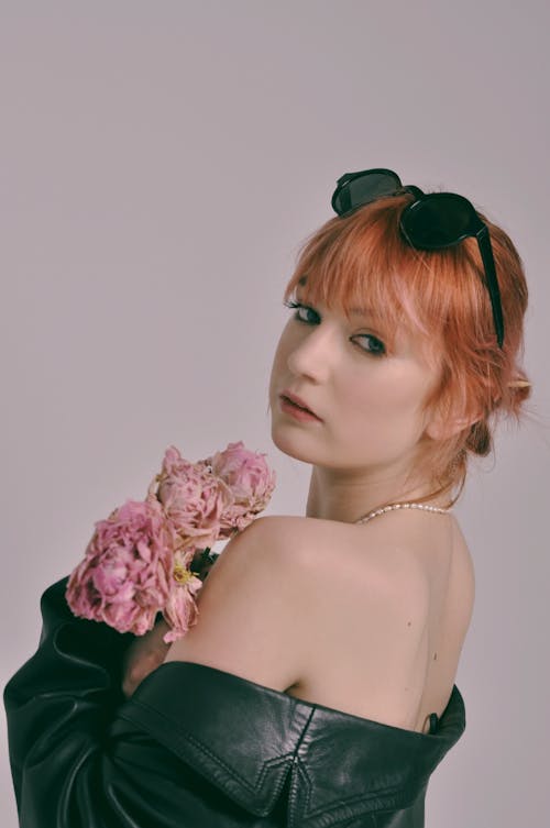 Woman with Colored Hair Holding Pink Flowers