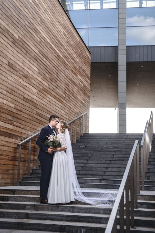 Free Married Couple Kissing on Stairs Stock Photo