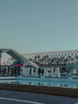 A vibrant scene with people at Valencia's City of Arts and Sciences in Spain, a modern architectural marvel.