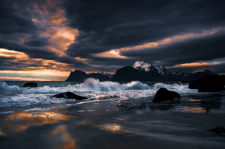 Waves Crashing On The Shore During Sunset