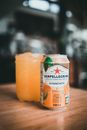Close-Up Shot of a Glass of Drink beside a Can
