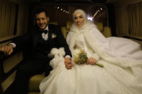 Married Couple Holding Hands Inside the Vehicle