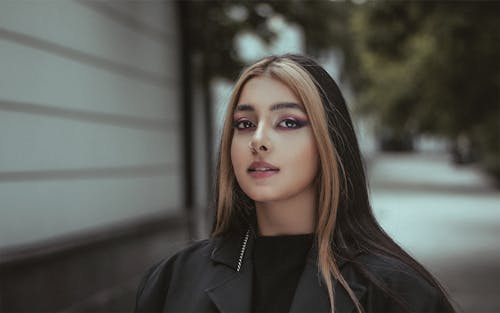 A Beautiful Woman in Black Blazer with Piercing on Her Nose