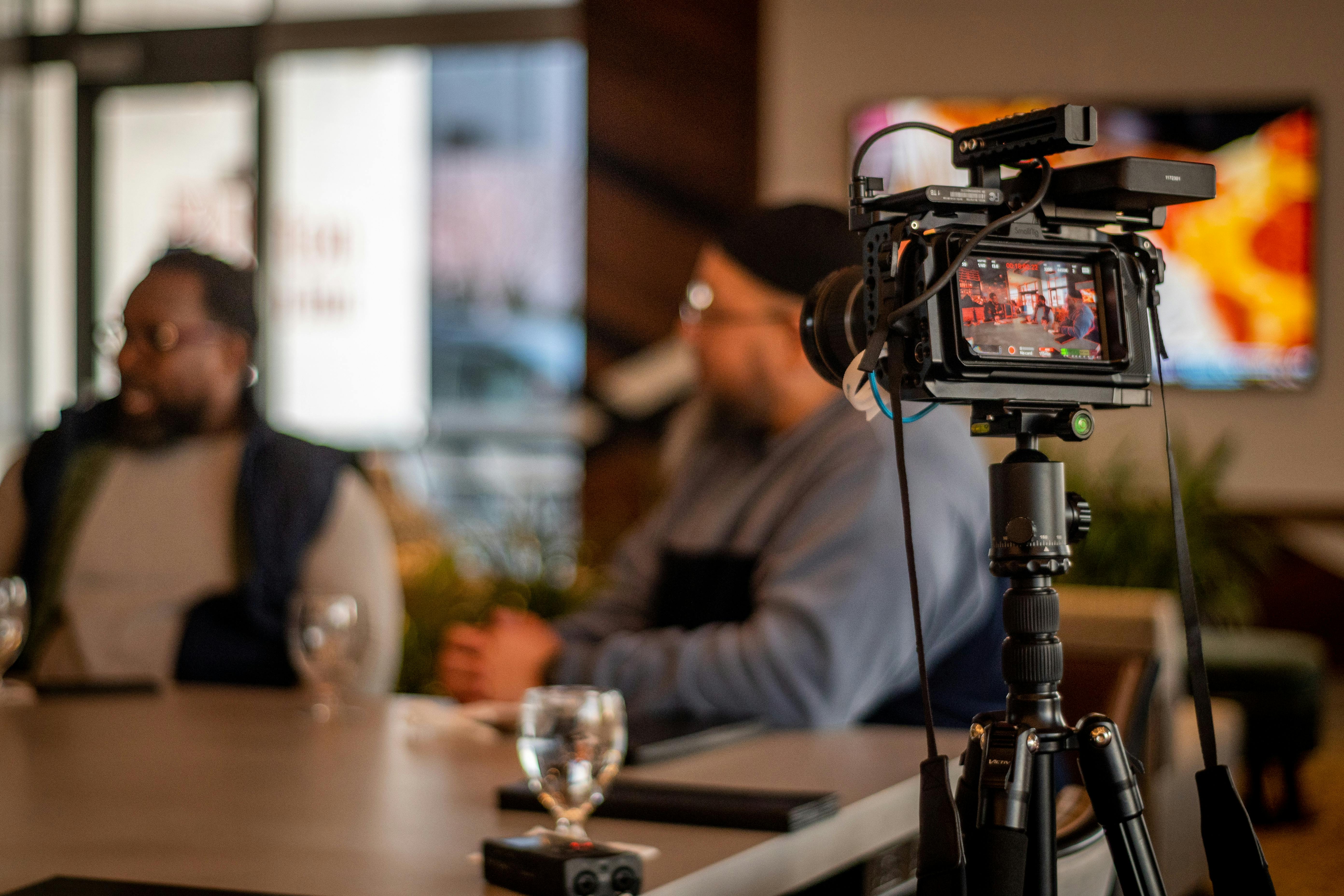 Professional video setup capturing a casual meeting at a café in Camden, NJ. Ideal for media projects.
