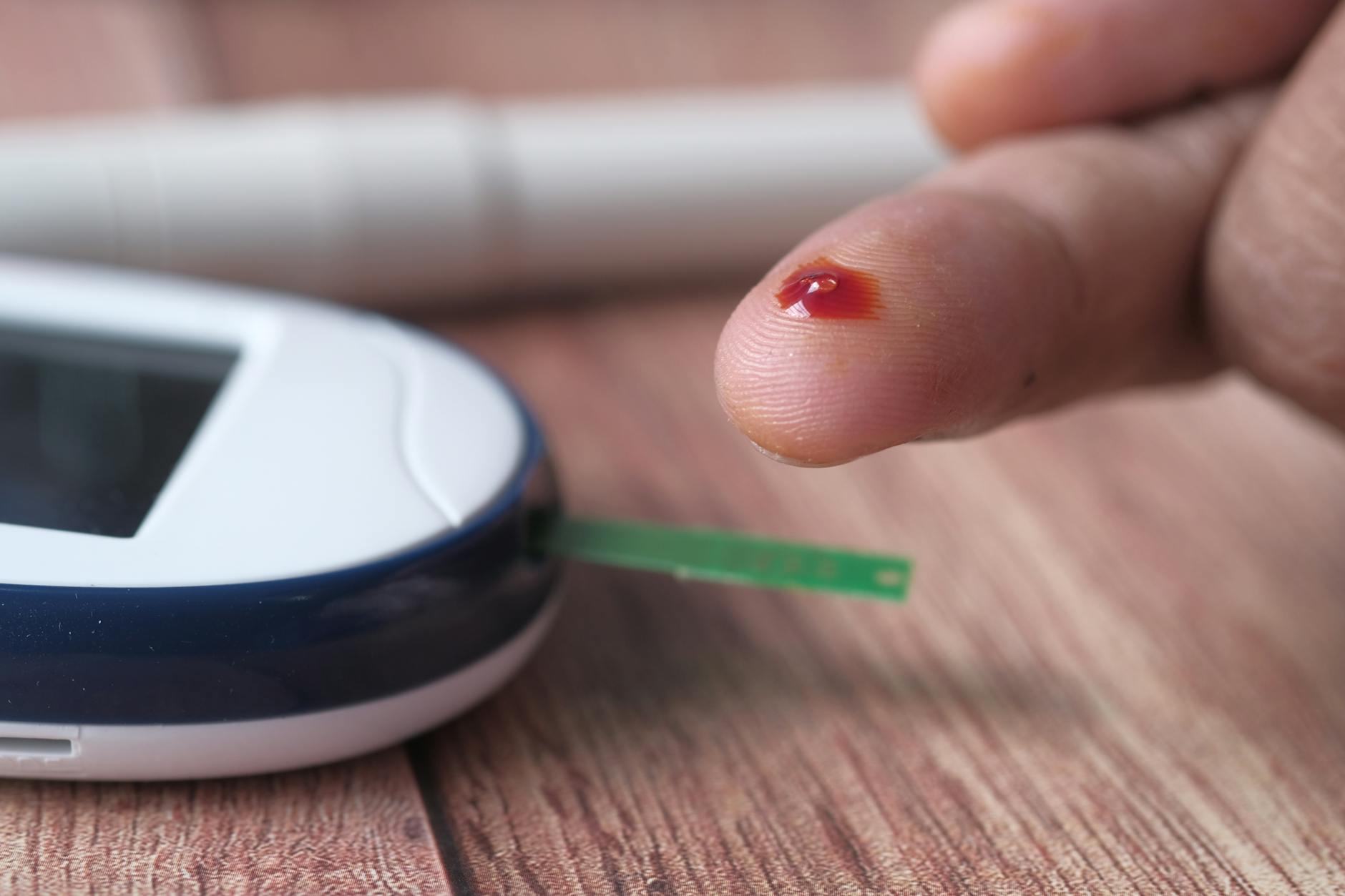 Close-up of Person Using a Blood Glucose Monitor