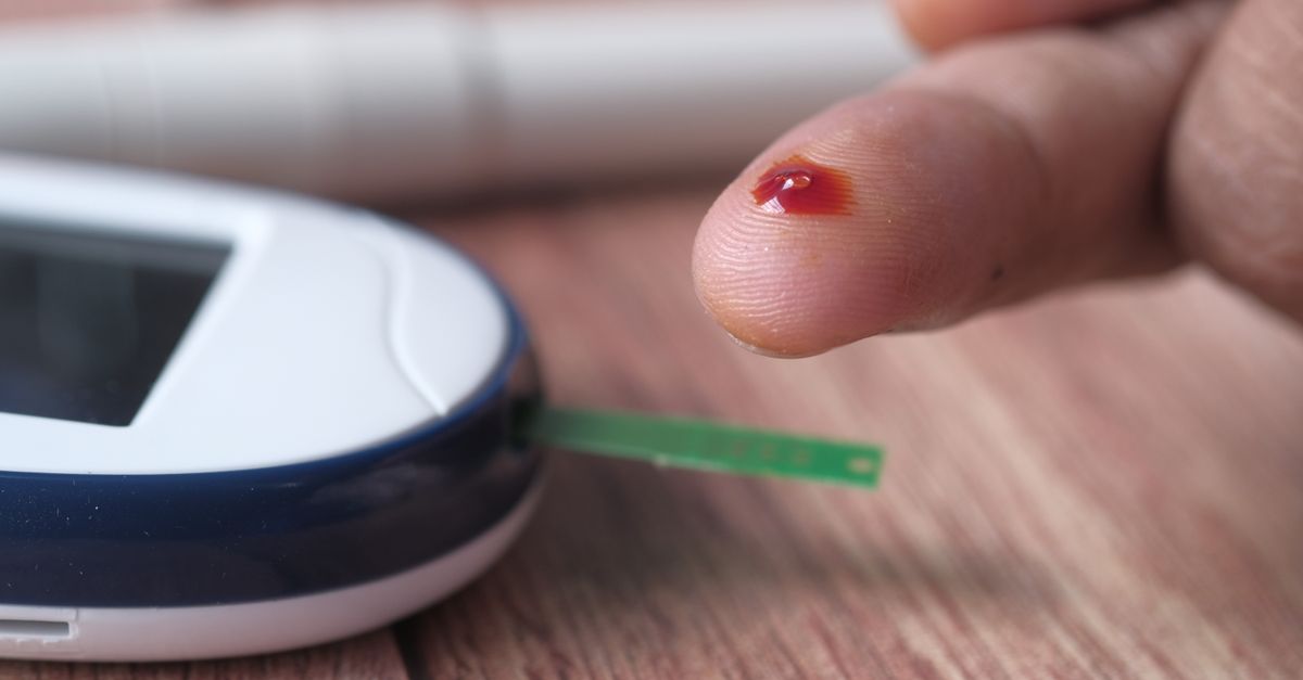 A close-up of a finger prick and blood glucose monitor for diabetes testing. - Evidence evidence guide for pomegranate blood glucose meta-analysis