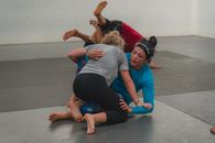 Woman in Gray T-shirt and Black Leggings Doing Yoga