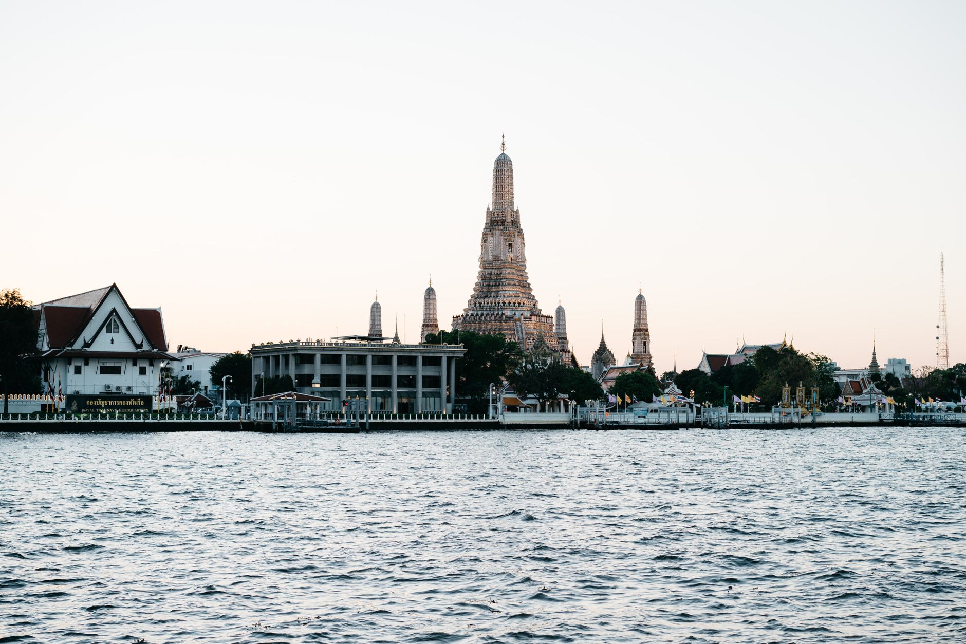 Chao Phraya river ferry passing Wat Arun at dusk