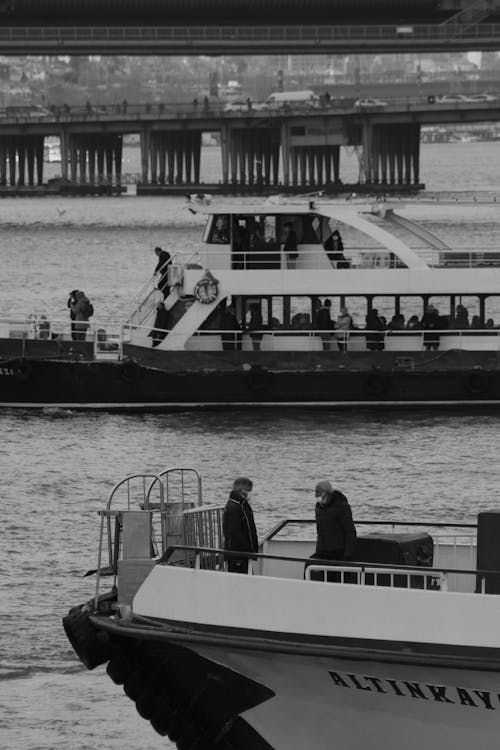 Grayscale Photo of People Riding on Boat