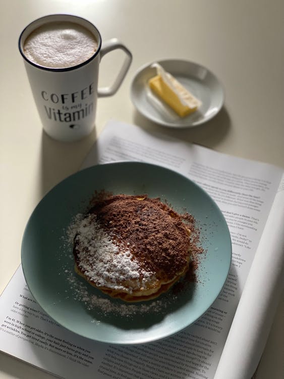 Pancakes with Chocolate Powder on a Blue Plate