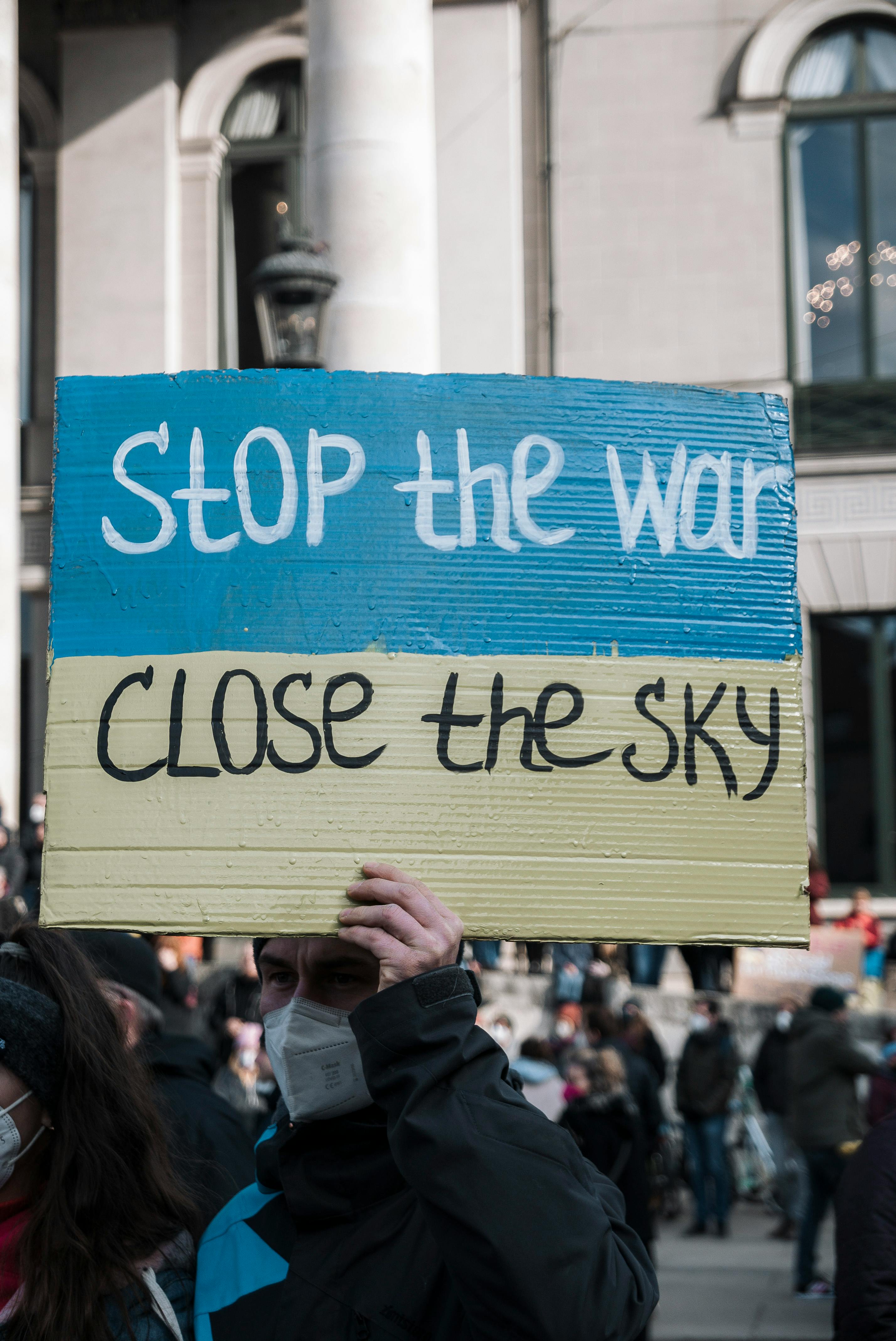 Activists in Munich hold signs advocating for peace during a protest.