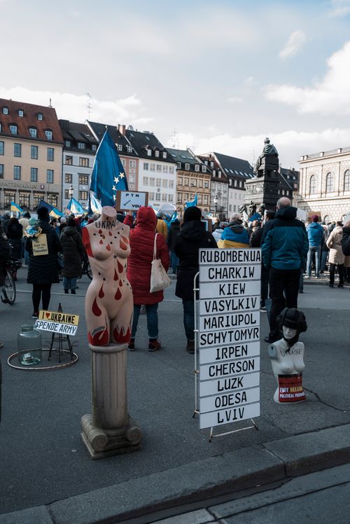 Free Crowd supporting Ukraine in Munich with flags and signs in a public square. Stock Photo