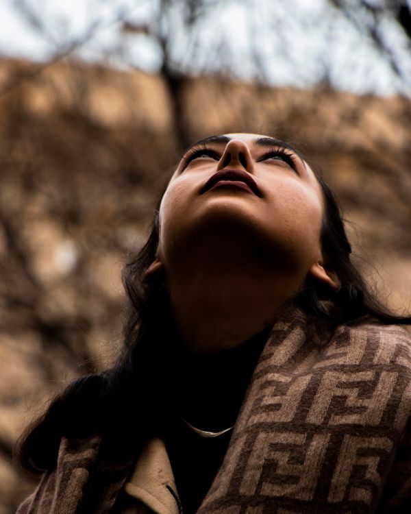 A Woman in Brown Coat Looking Up on the Sky · Free Stock Photo