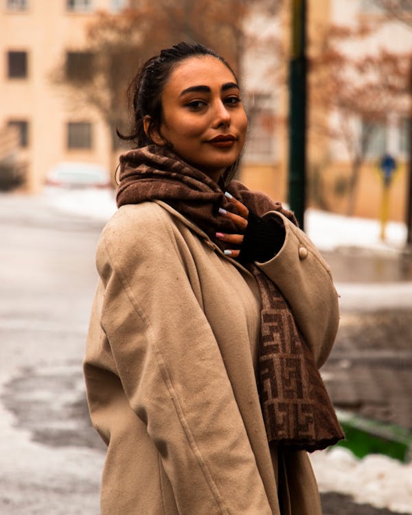 A Woman in Beige Coat with Brown Scarf on His Neck