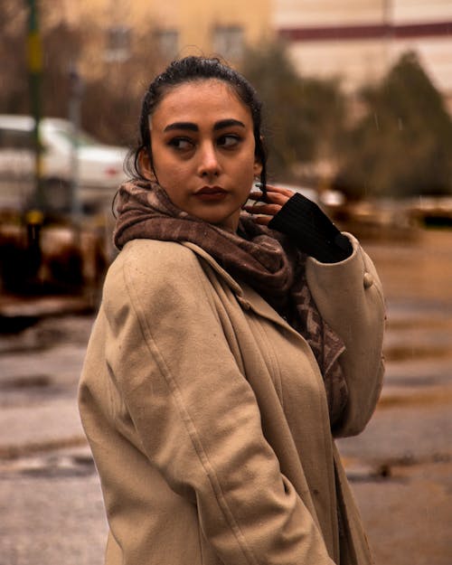 Woman in Brown Coat Looking Sideways 