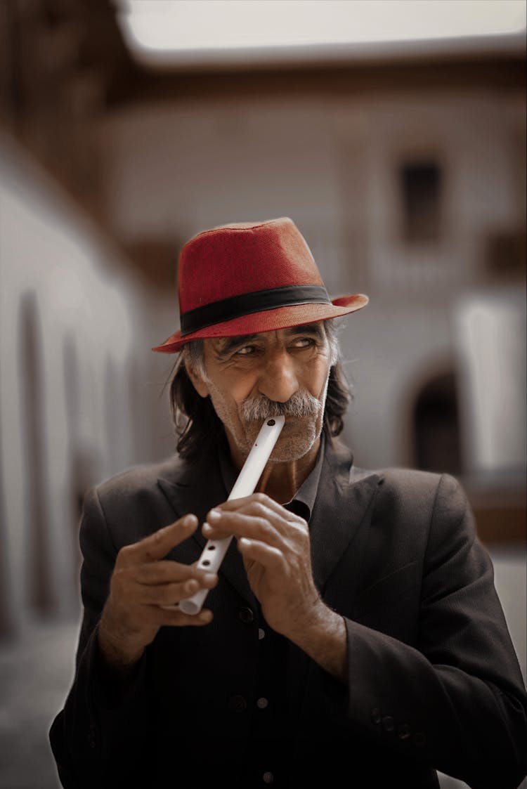 A Man Playing A Flute