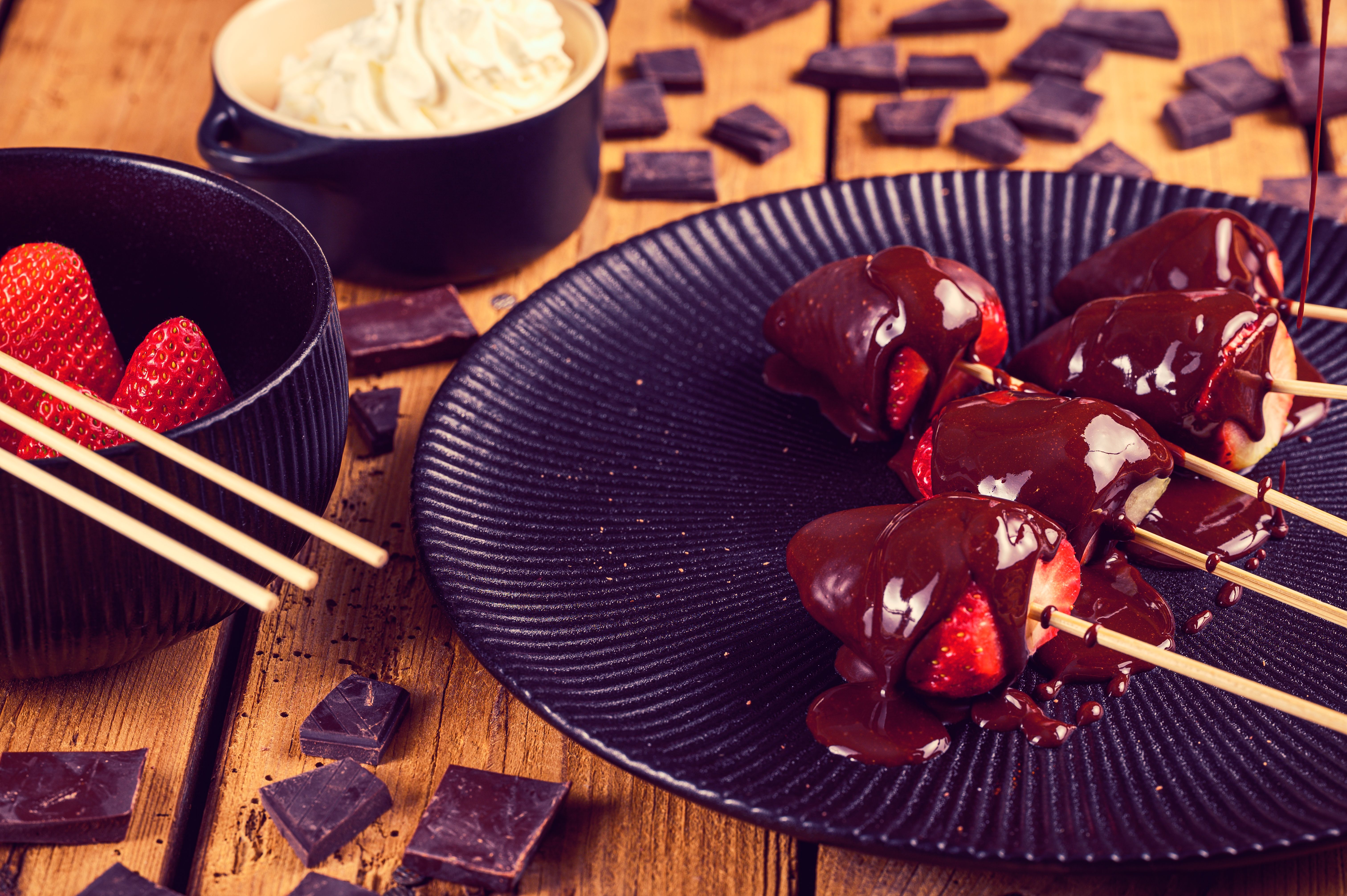 A close-up of strawberries dipped in rich chocolate, perfect for a sweet treat.