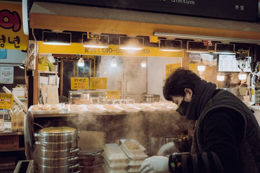A vendor in Guri City, South Korea, prepares dim sum at a steaming food stall.