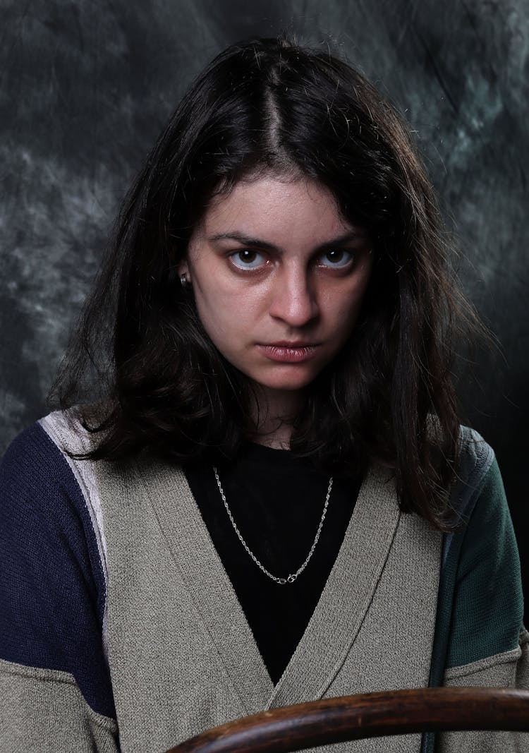 Woman In Cardigan With A Fierce Look