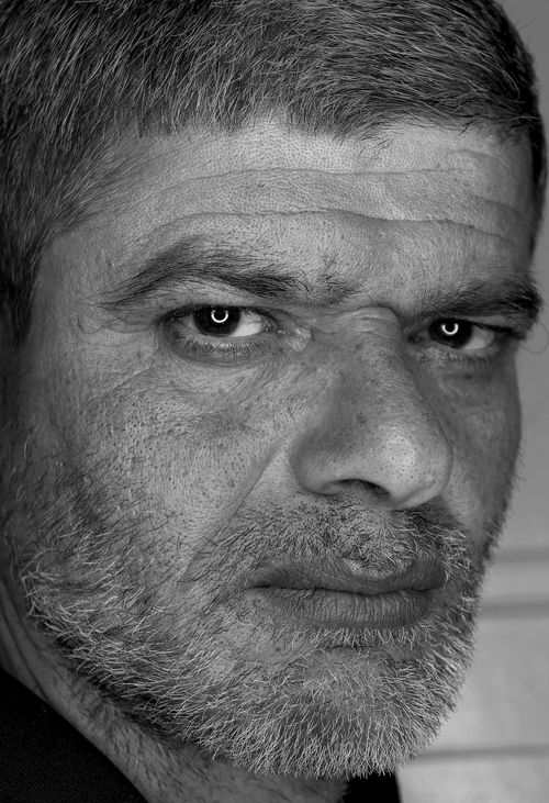 Free Intense black and white close-up portrait of an elderly man with facial hair and deep wrinkles. Stock Photo
