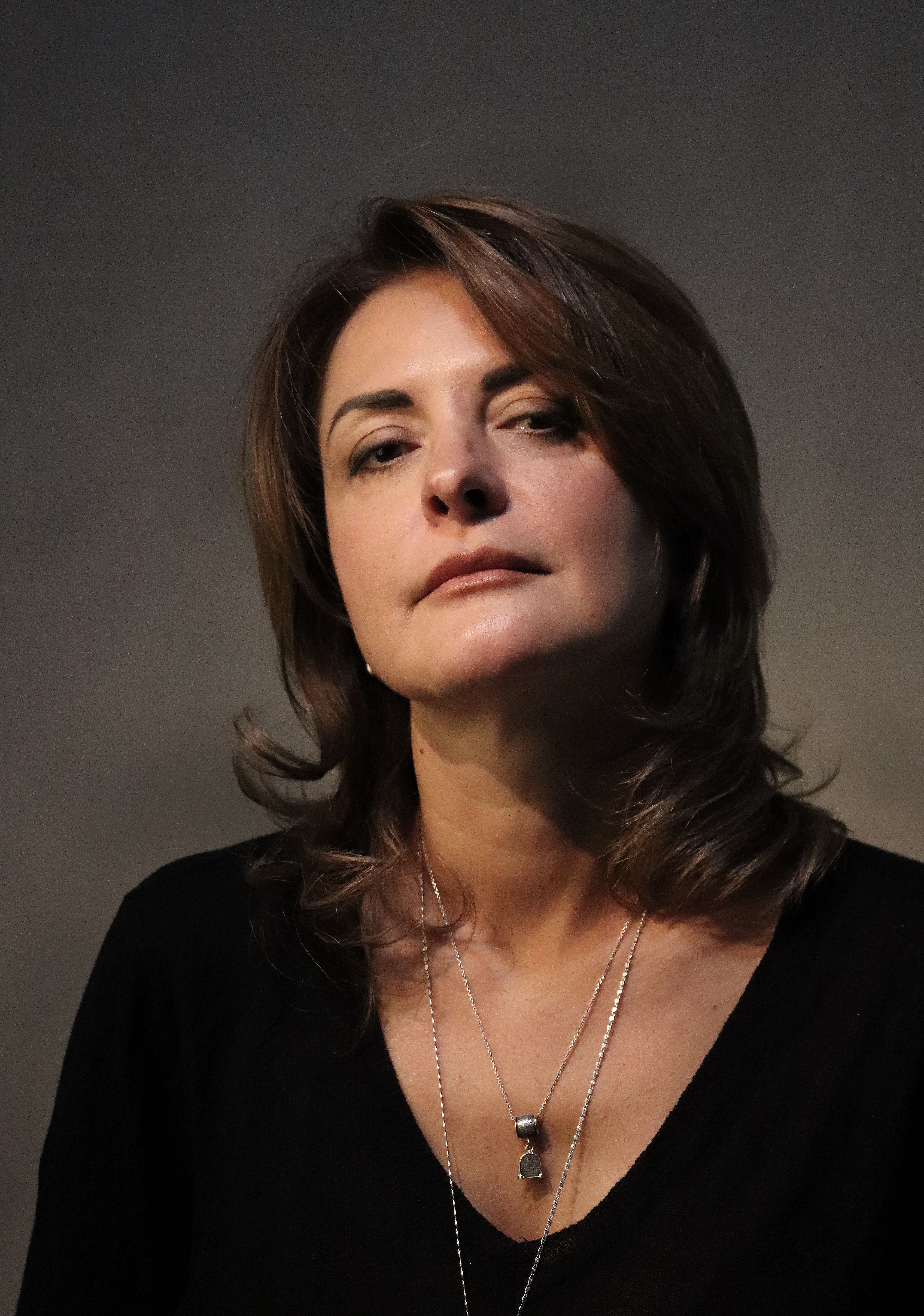 A classic portrait of a woman with a contemplative expression, highlighting elegance and poise.