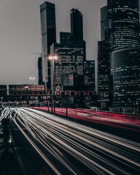 Long exposure shot of Moscow skyline, showcasing dynamic light trails under the night sky.