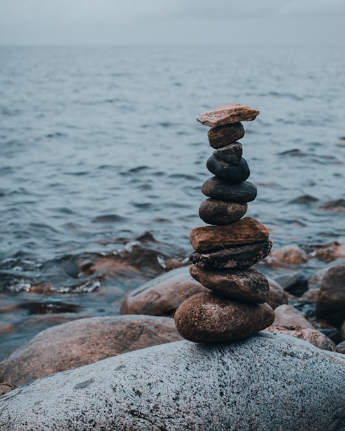Free Stack of Stones on Gray Rock Near Body of Water Stock Photo