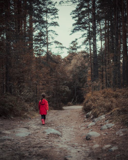 Girl Wearing a Red Raincoat Walking